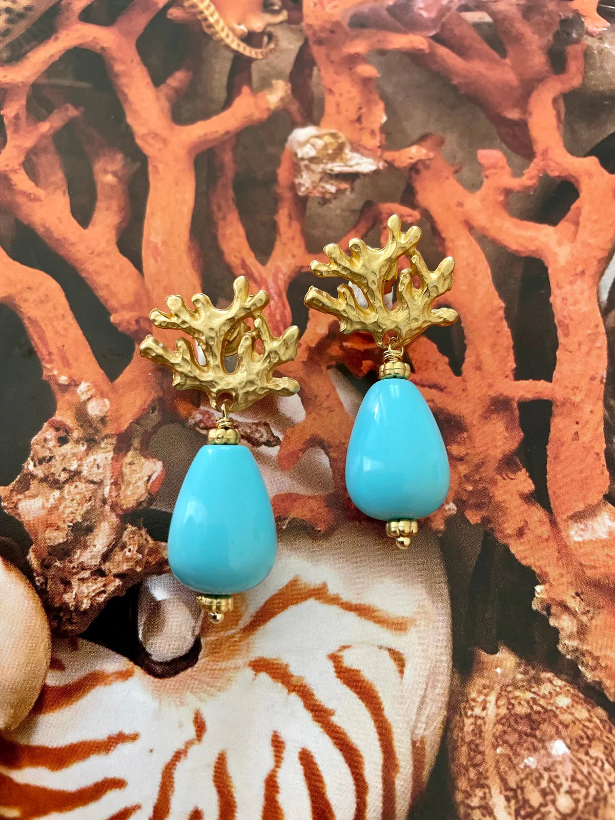 Handcrafted ocean-inspired Ravello Earrings with turquoise drops and matte gold coral posts, perfect for summer outfits.